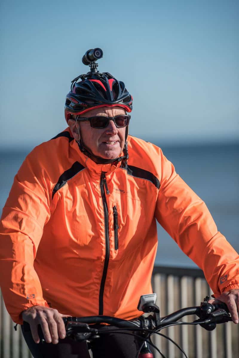 Man in orange reflective jacket wearing the DC-1 Dual Lens attached to the helmet