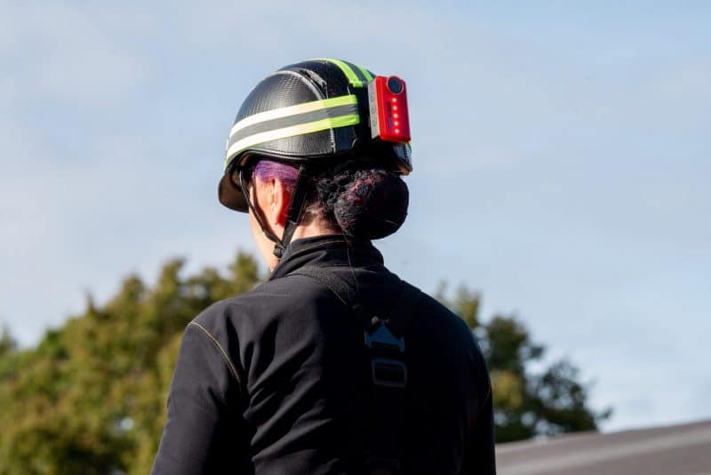 Woman wearing the CR-1 REAR LIGHT attached to her helmet