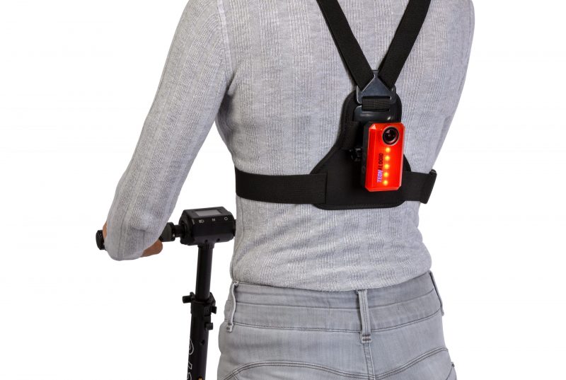 Woman wearing E-scooter accessories, the CR-1 REAR LIGHT