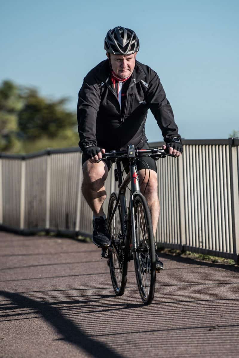 Man cycling with the CF-1 FRONT LIGHT