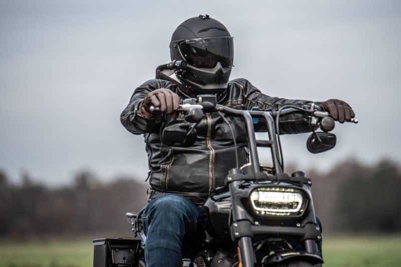 Man riding motorcycle with DC-1 Dual Lens Helmet Camera