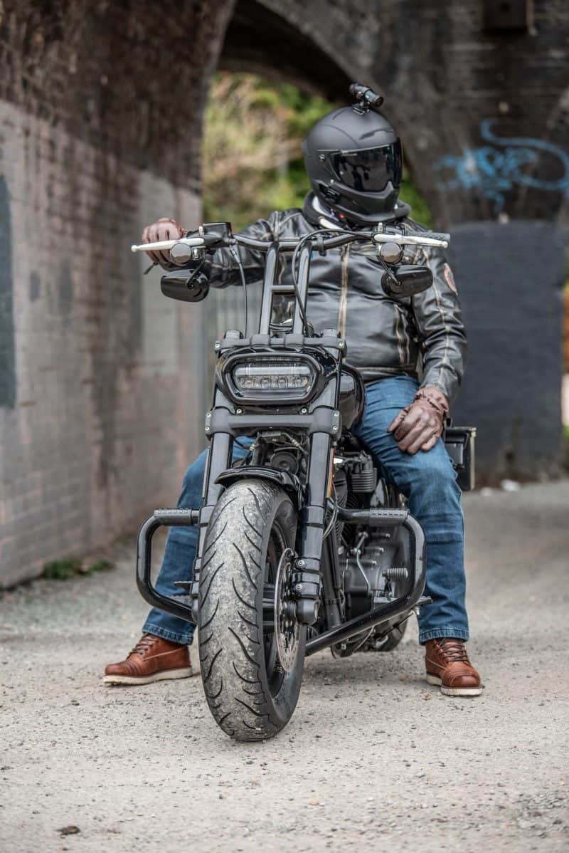 Man sitting on motorcycle with DC-1 Dual Lens Helmet Camera attached