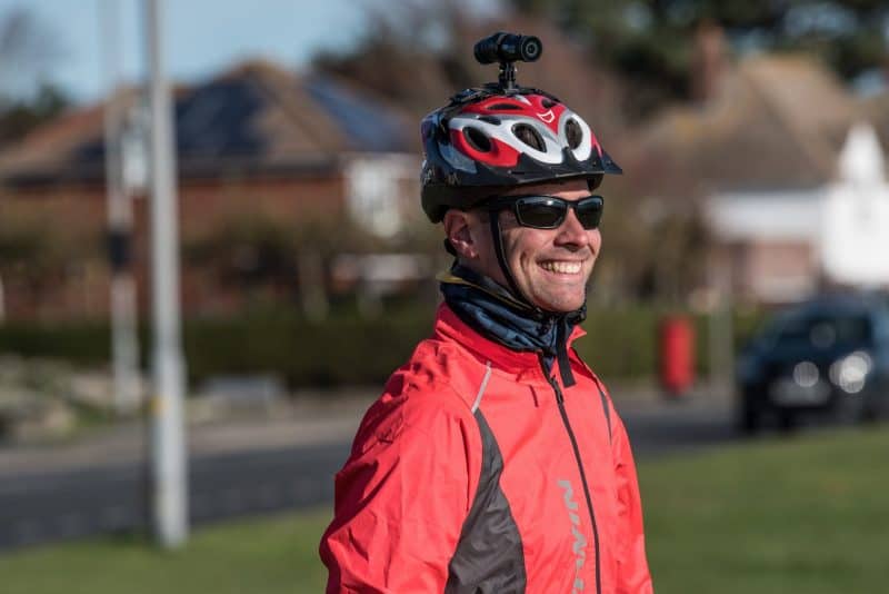 Man smiling and wearing the DC-1 Dual Lens Helmet Camera