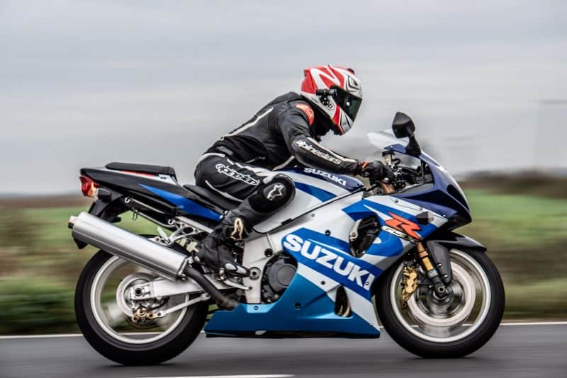 Man riding blue Suzuki motorbike with the XV-1 2K QHD Helmet Camera