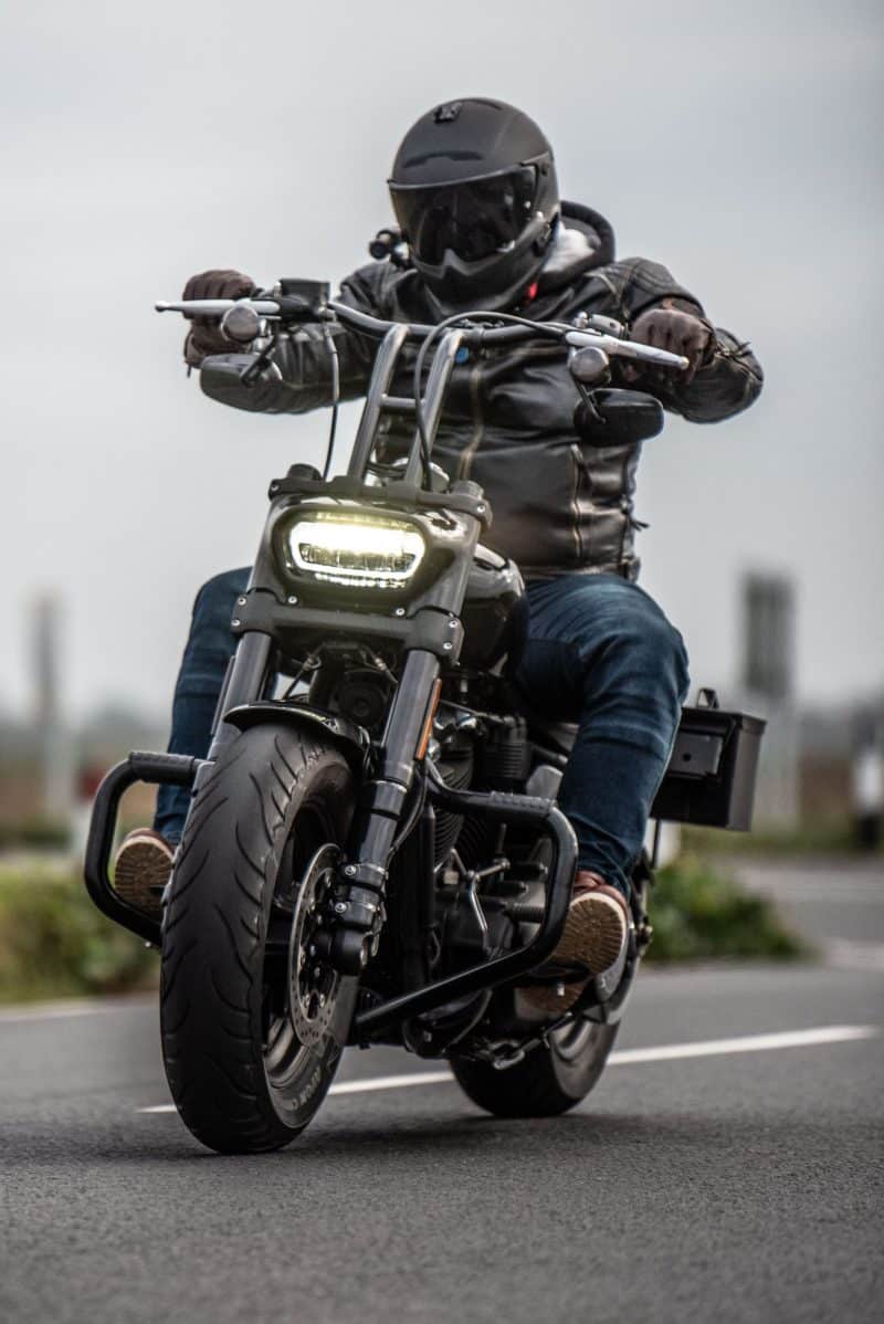 Man riding motorcycle with DC-1 Dual Lens Helmet Camera attached