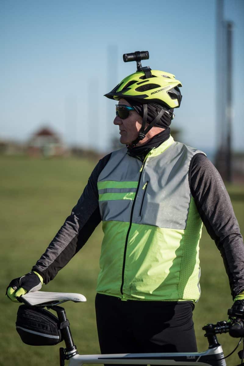 Man wearing green Hi-vis and green bike helmet with the XV-1 2K QHD Helmet Camera attached